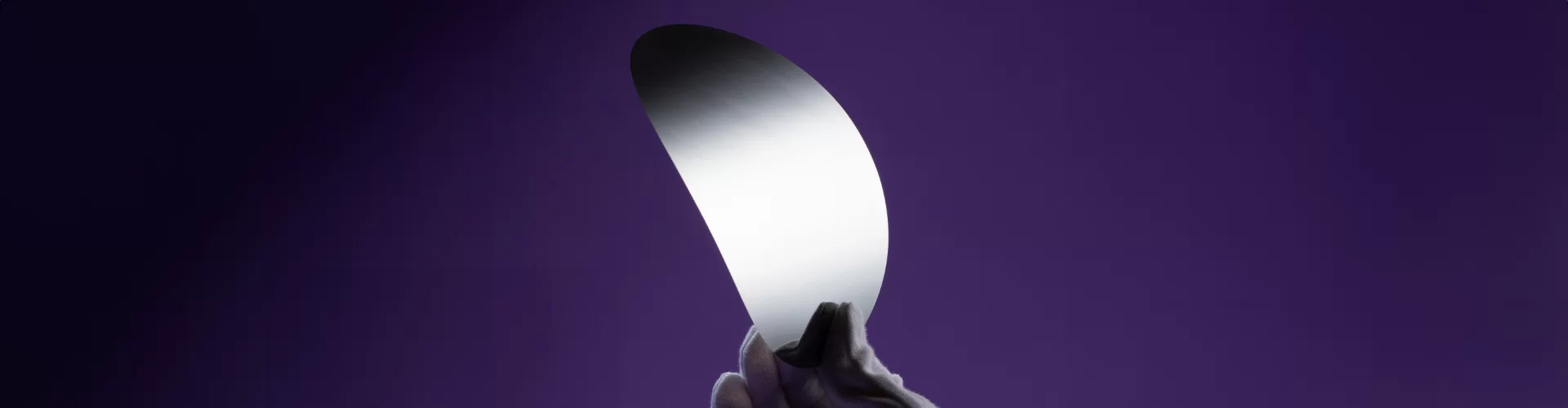 extremely thin metal sliver being held by a gloved hand