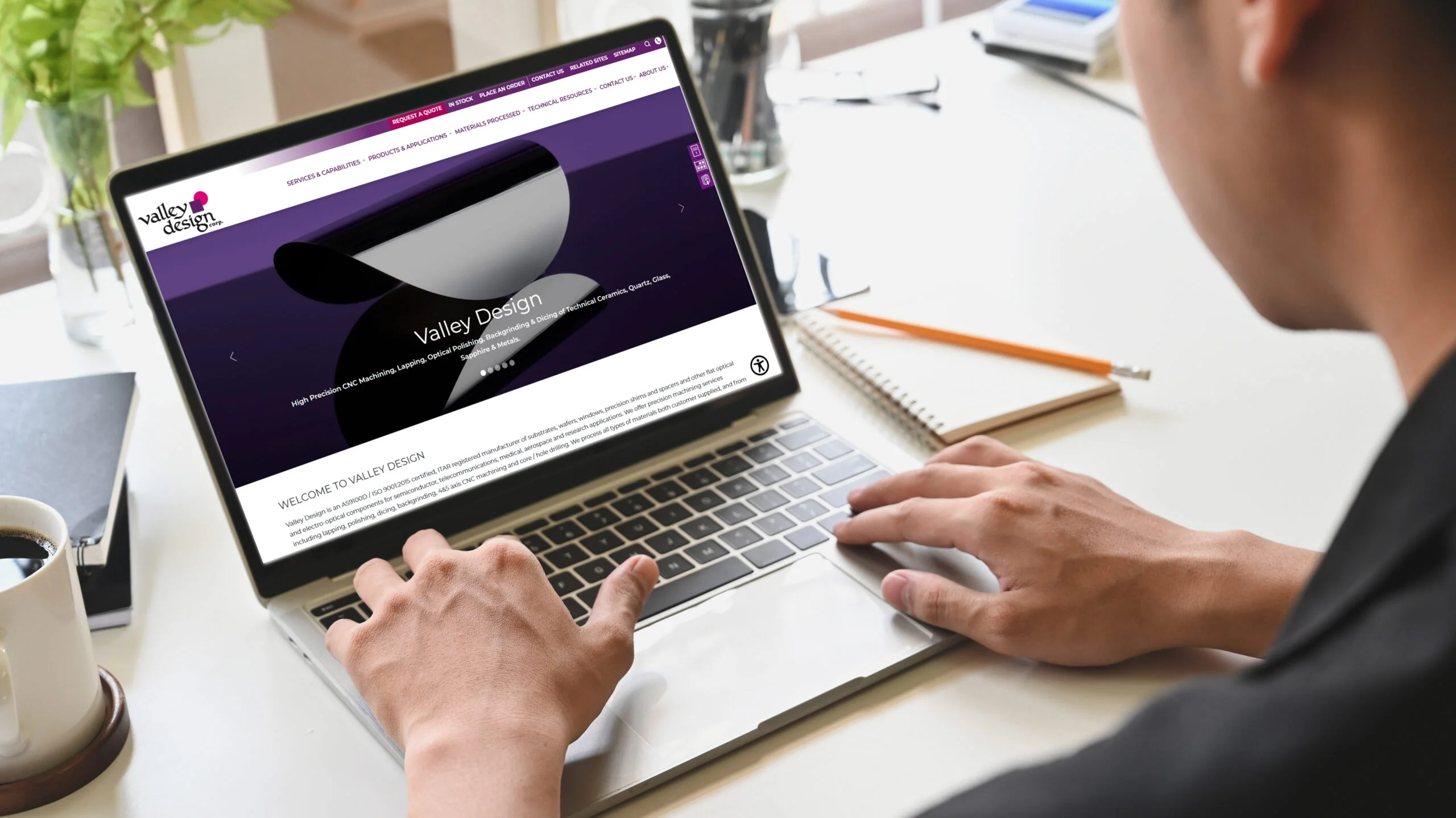 Man Browsing Valley Design Home Page on Laptop